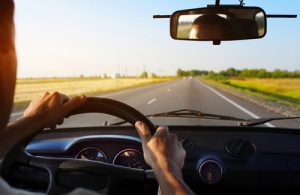 Drivers's hands on stearing wheel of a car